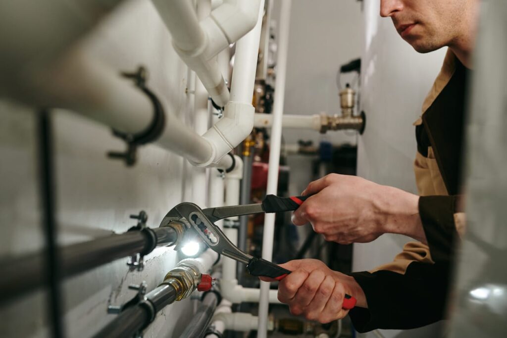 Plumbers maintaining commercial plumbing pipes in Littleton